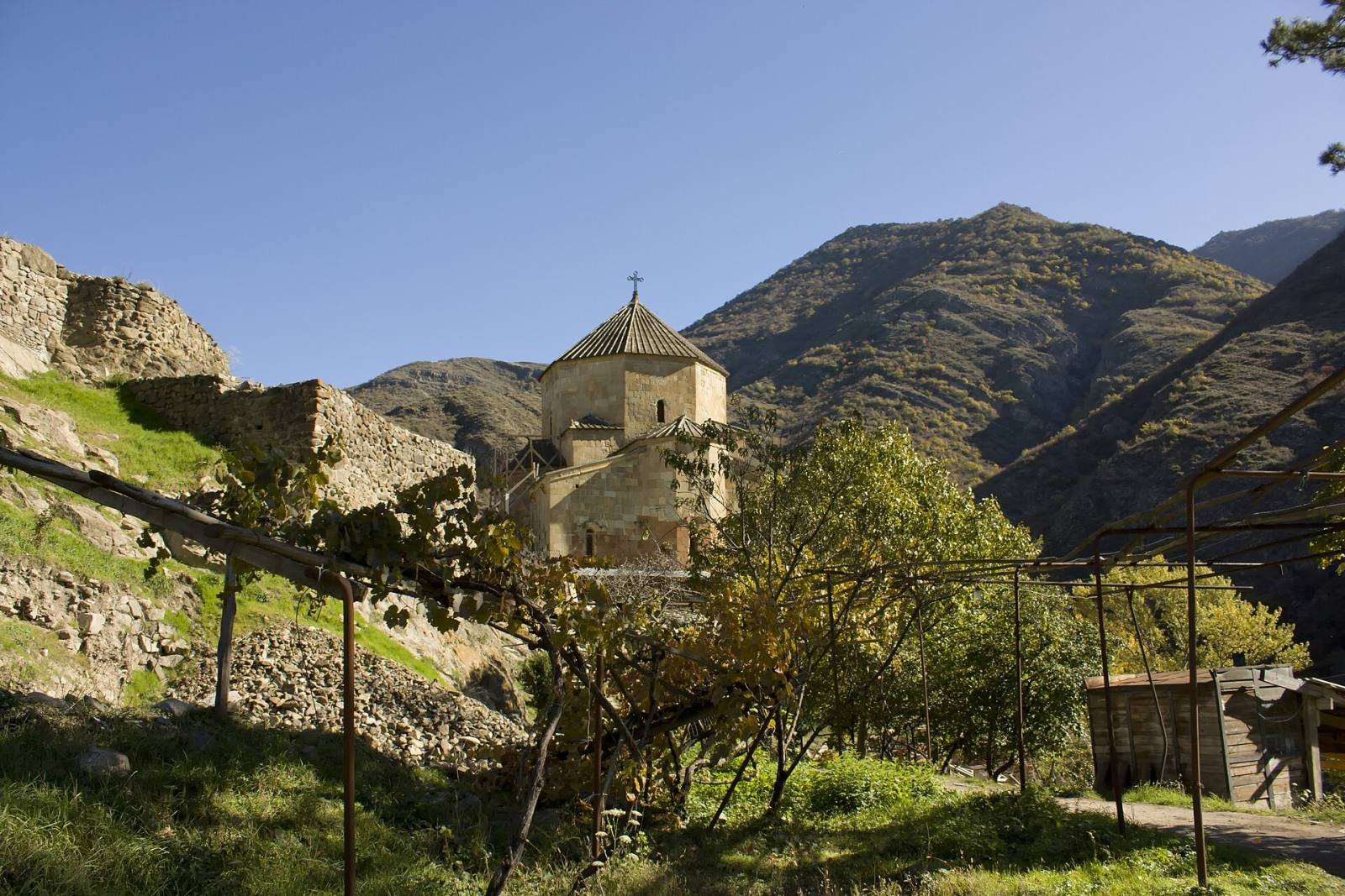 The church of Ateni Sioni among trees in the Ateni valley, below steep rocky hills