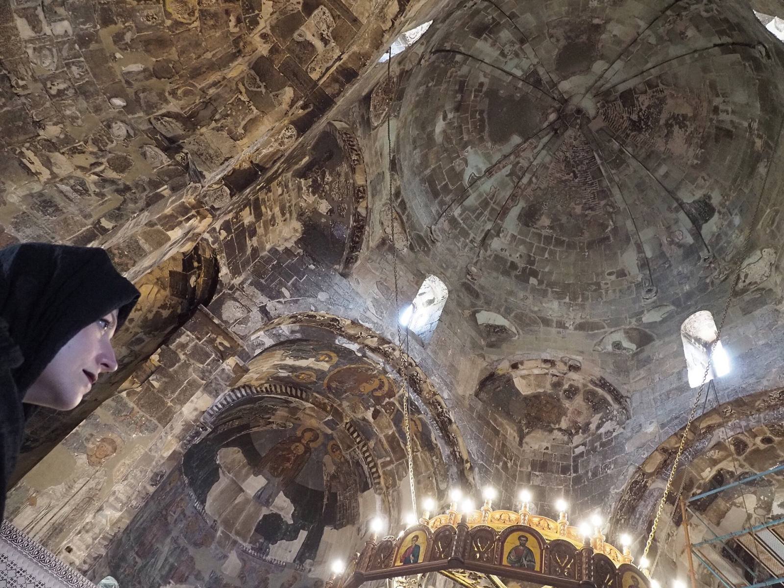 Medieval frescoes on the walls and dome inside Ateni Sioni church, lit by a chandelier