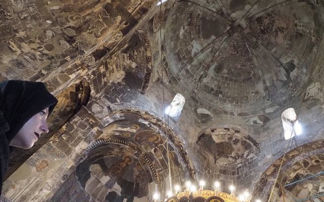 Medieval frescoes on the walls and dome inside Ateni Sioni church, lit by a chandelier