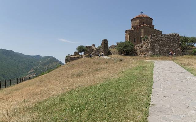 Jvari Monastery, a domed stone church, on a grassy hilltop above Mtskheta
