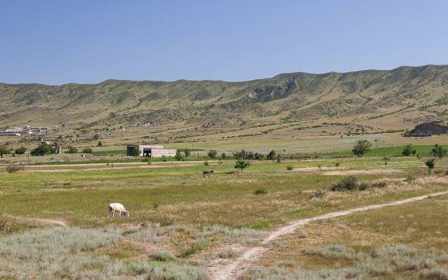Green hills and fields in the Mtkvari valley, seen from a train between Tbilisi and Kutaisi